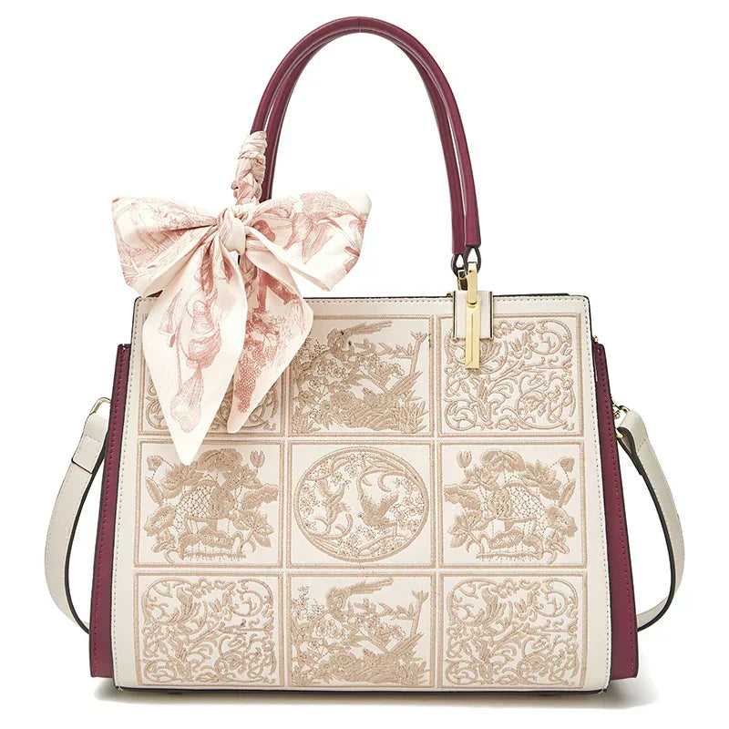 Sylvia™ – Unikalna torebka crossbody z haftem i kokardą