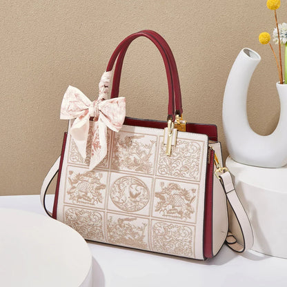 Sylvia™ – Unikalna torebka crossbody z haftem i kokardą